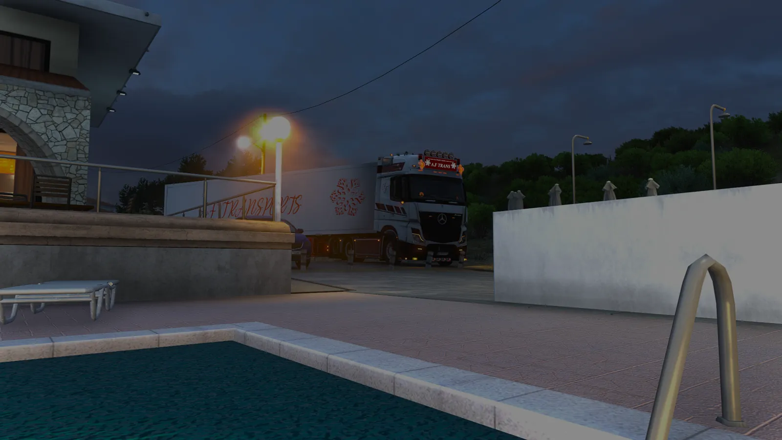 Mercedes Actros AF Trans à l’arrêt devant un hôtel, à la tombée de la nuit